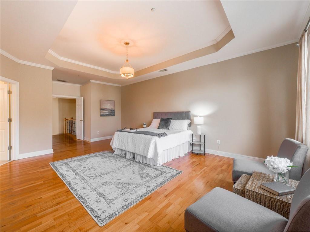 1051 Emory Parc Place Decatur, GA 30033 - Photo 11 of 30 a bedroom with a bed and wooden floor