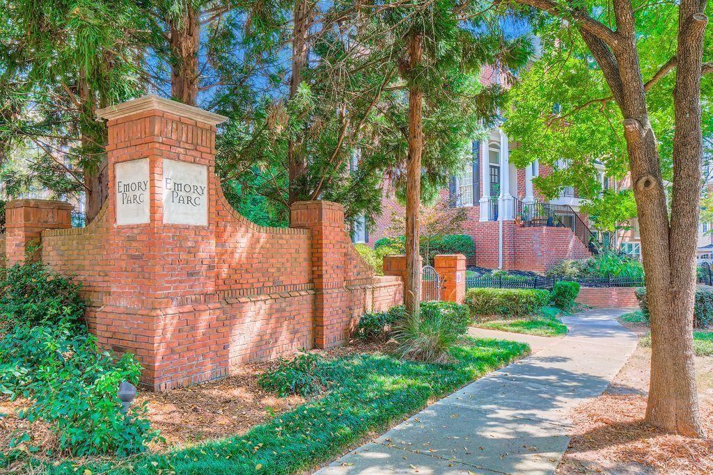 1051 Emory Parc Place Decatur, GA 30033 - Photo 25 of 30 a front view of a house with a yard and large trees