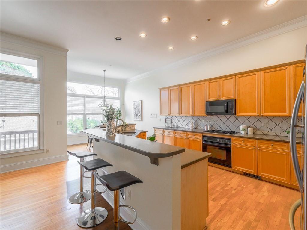 1051 Emory Parc Place Decatur, GA 30033 - Photo 6 of 30 a kitchen with stainless steel appliances granite countertop a sink counter space and a large window