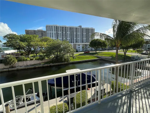 a view of a balcony with wooden floor & fence