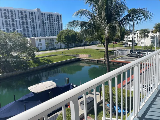 a view of a lake with a table and chairs
