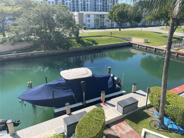 a view of a lake with tall building in front of it