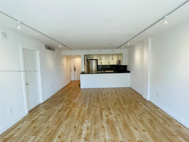 a view of a kitchen with a sink and cabinets