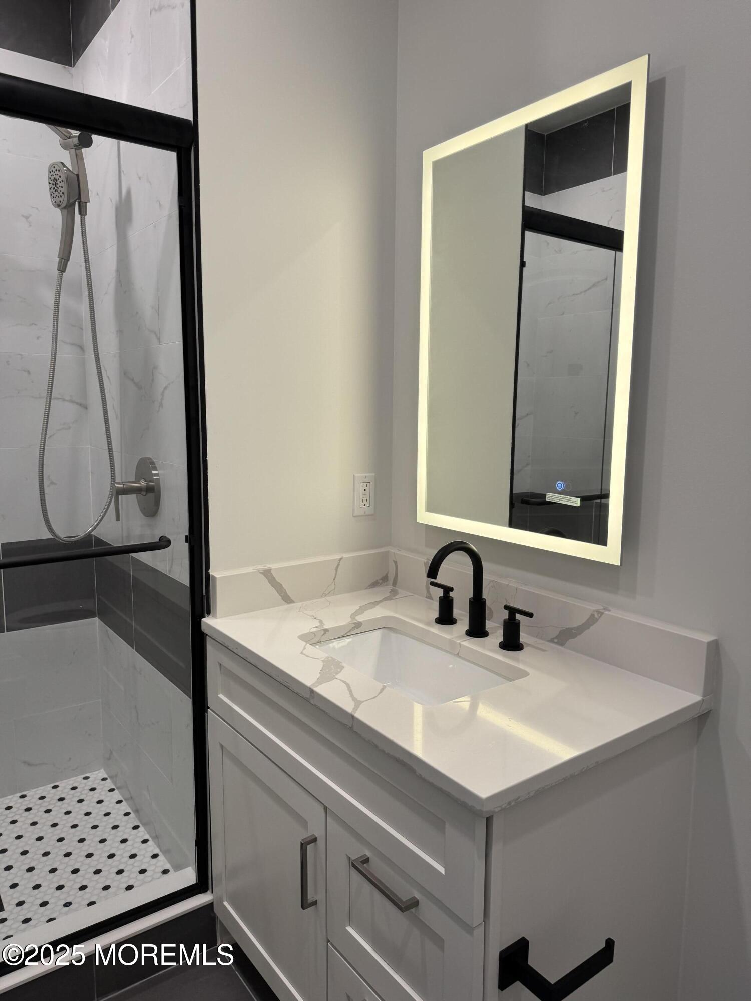 179 Chelsea Avenue, Unit 201 Long Branch, NJ 07740 - Photo 4 of 6 a bathroom with a sink and a mirror