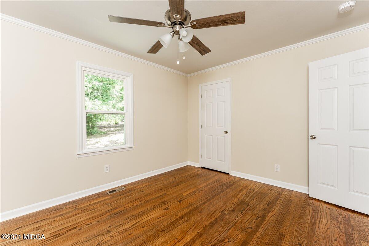 5611 Sardis Church Road Macon, GA 31216 - Photo 13 of 32 wooden floor in an empty room with a window