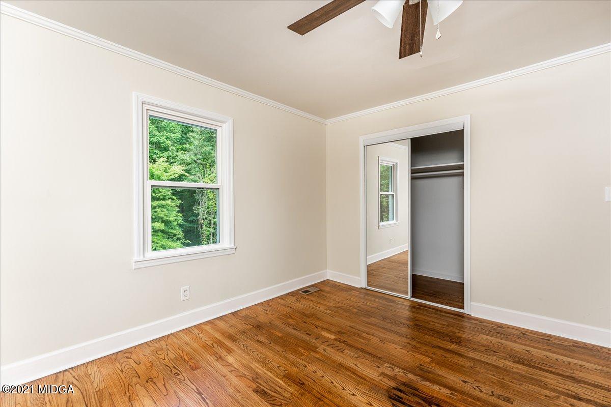 5611 Sardis Church Road Macon, GA 31216 - Photo 16 of 32 an empty room with wooden floor closet and windows