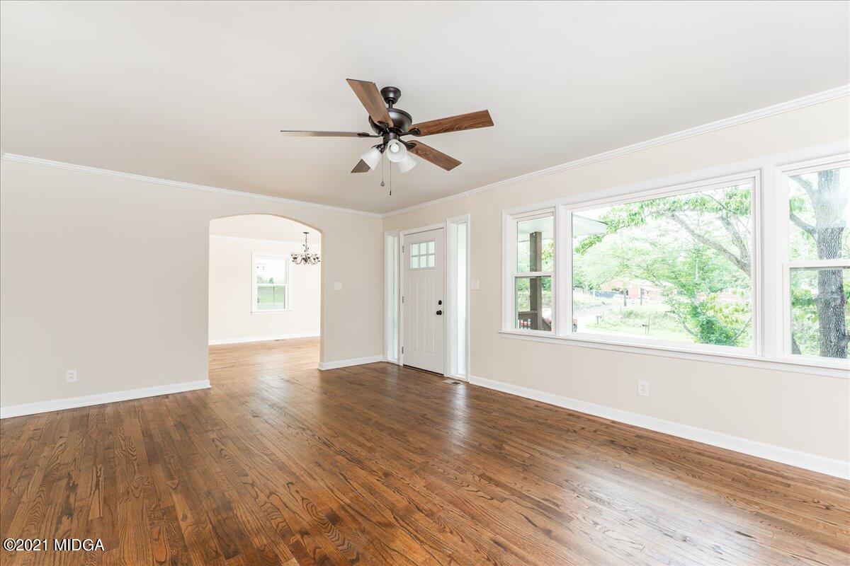 5611 Sardis Church Road Macon, GA 31216 - Photo 17 of 32 a view of an empty room with wooden floor and a window