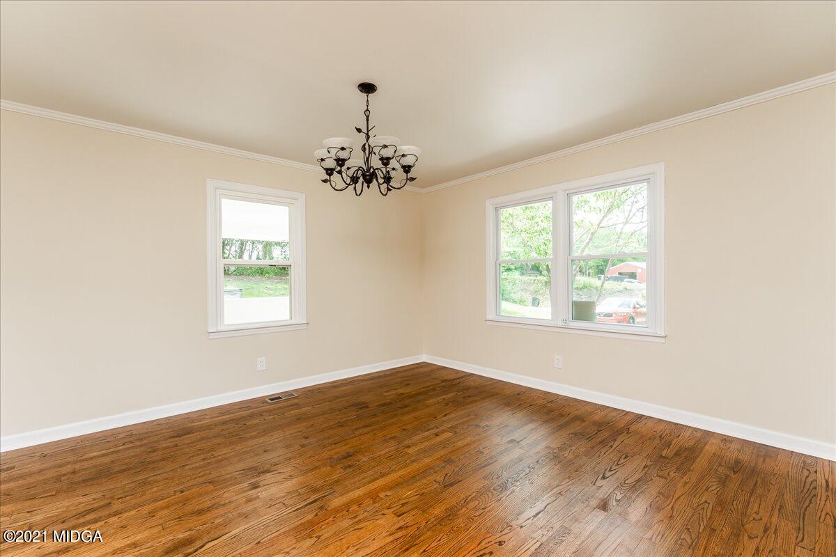 5611 Sardis Church Road Macon, GA 31216 - Photo 19 of 32 a view of an empty room with wooden floor and a window