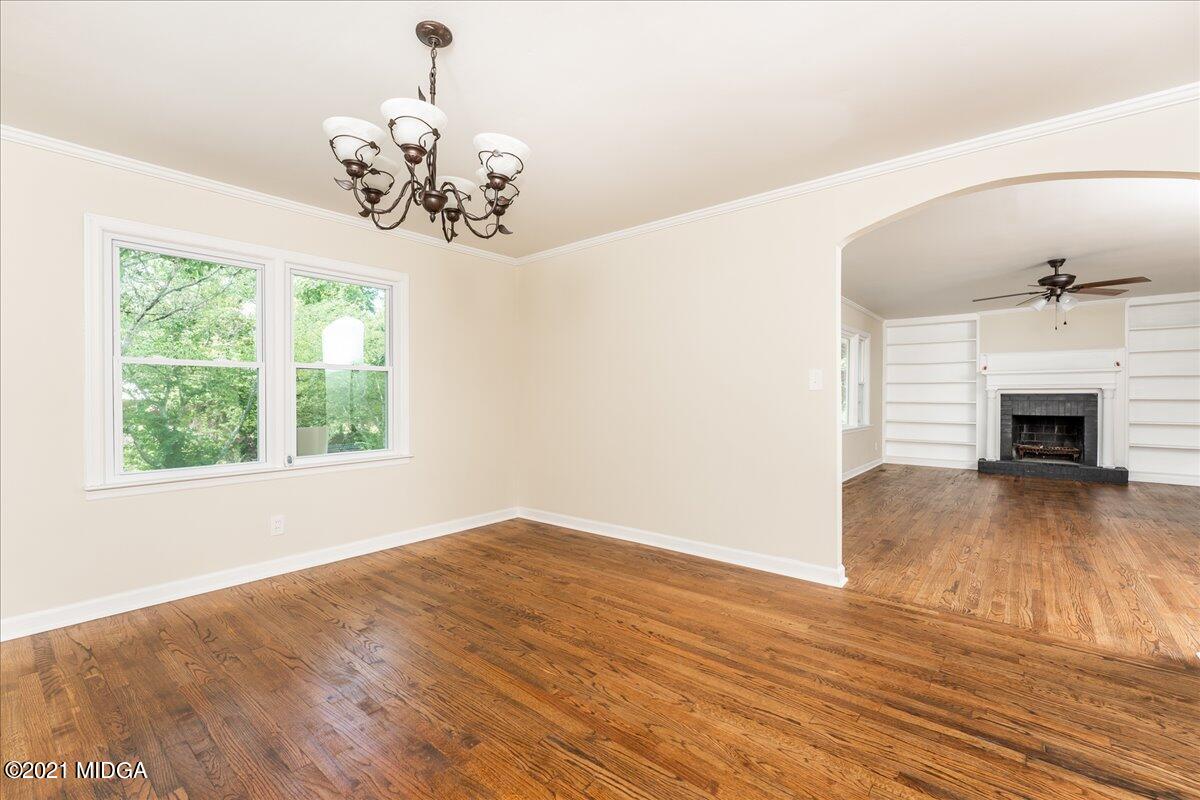 5611 Sardis Church Road Macon, GA 31216 - Photo 20 of 32 a view of a livingroom with a fireplace wooden floor and a chandelier