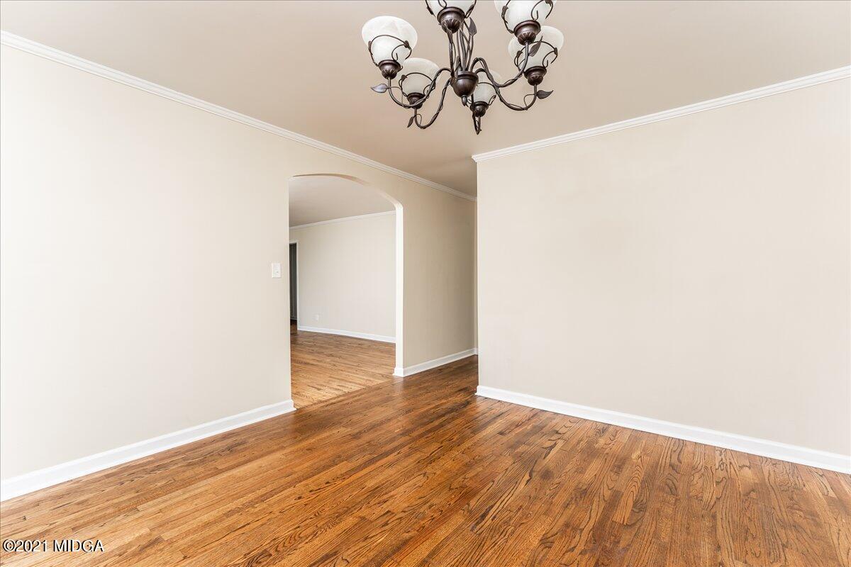 5611 Sardis Church Road Macon, GA 31216 - Photo 21 of 32 a view of a hallway with wooden floor and a chandelier