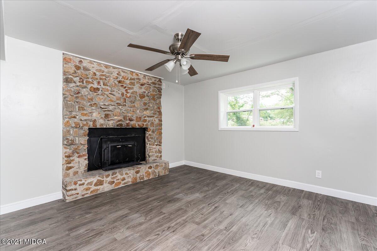 5611 Sardis Church Road Macon, GA 31216 - Photo 25 of 32 an empty room with windows fireplace and a sink