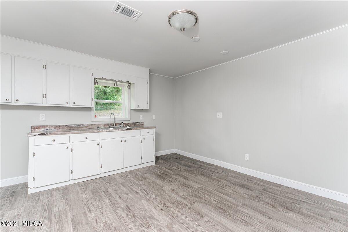 5611 Sardis Church Road Macon, GA 31216 - Photo 26 of 32 a room with a sink cabinets and a window