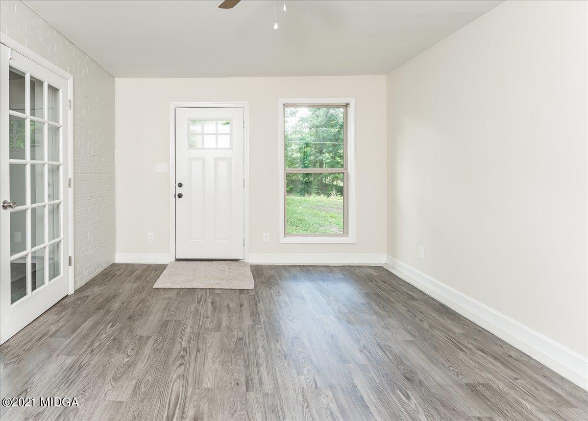 5611 Sardis Church Road Macon, GA 31216 - Photo 27 of 32 an empty room with wooden floor and windows