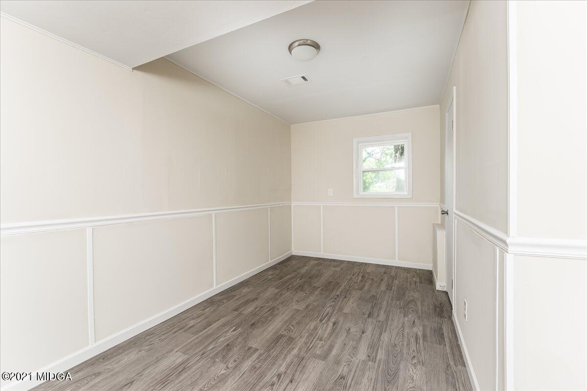 5611 Sardis Church Road Macon, GA 31216 - Photo 31 of 32 a view of an empty room with wooden floor and a window