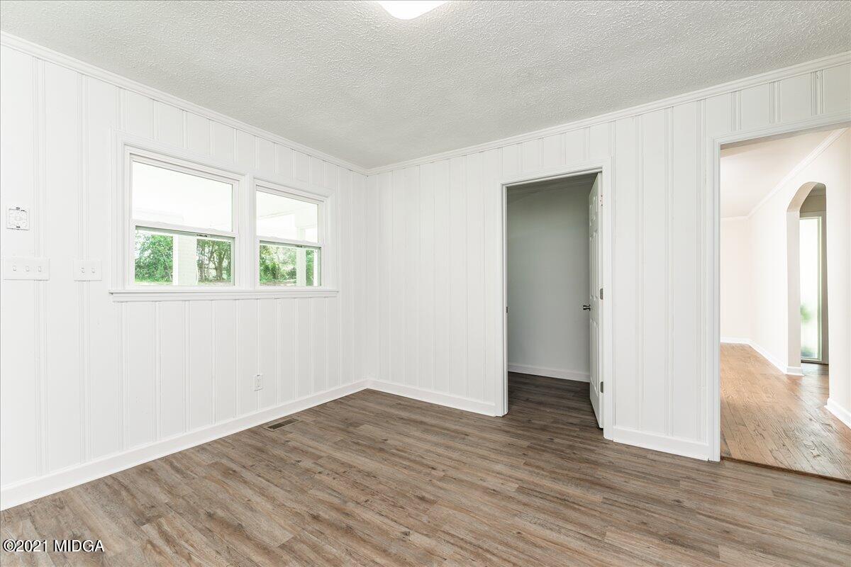 5611 Sardis Church Road Macon, GA 31216 - Photo 8 of 32 an empty room with wooden floor and windows