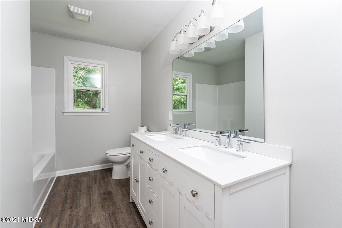 5611 Sardis Church Road Macon, GA 31216 - Photo 9 of 32 a bathroom with a sink a toilet and a mirror