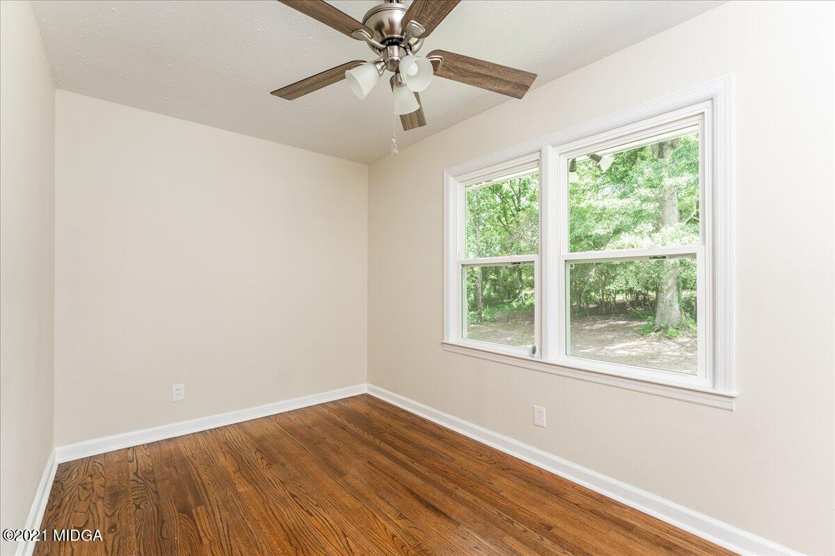 5611 Sardis Church Road Macon, GA 31216 - Photo 10 of 32 a view of an empty room with wooden floor and a window