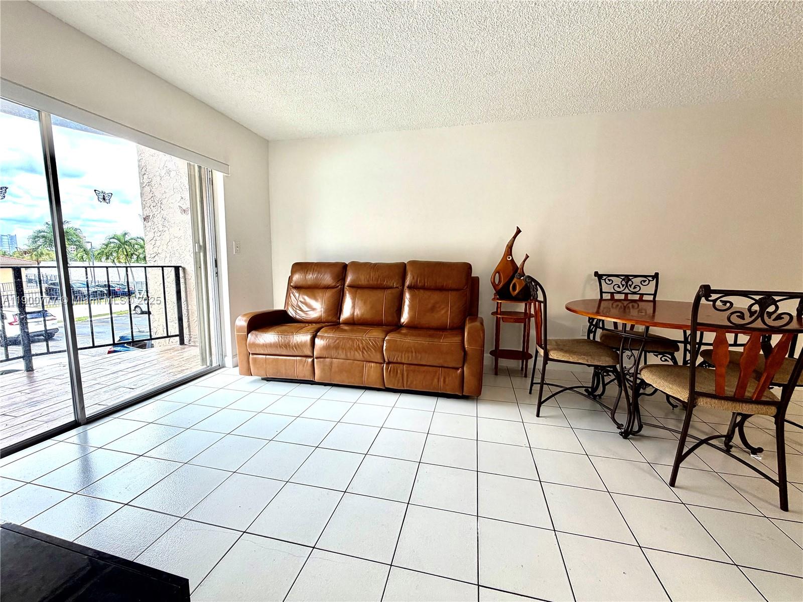 5201 Northwest 7th Street, Unit 212 Miami, FL 33126 - Photo 17 of 34 a living room with furniture