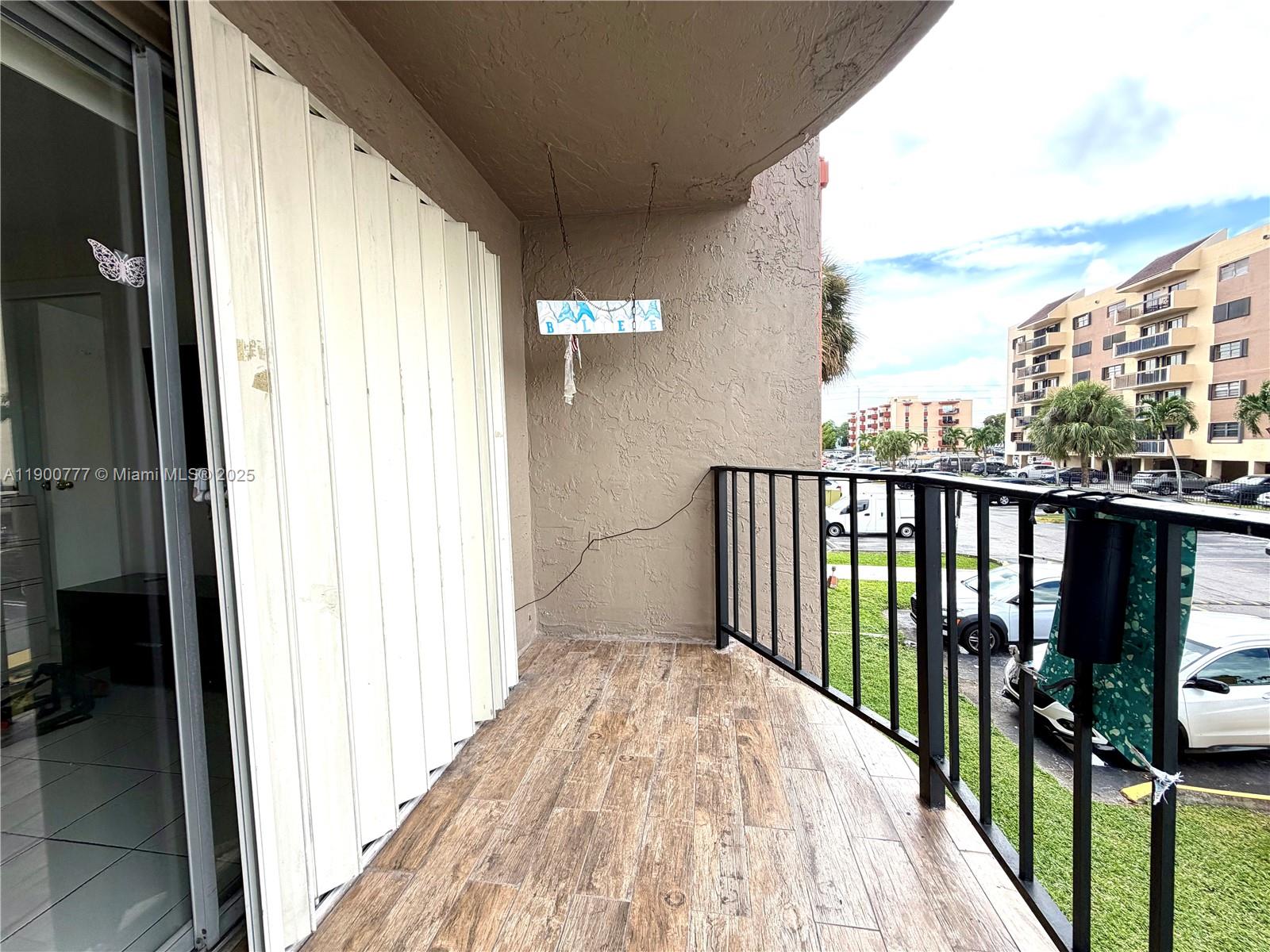 5201 Northwest 7th Street, Unit 212 Miami, FL 33126 - Photo 23 of 34 a view of balcony with wooden floor