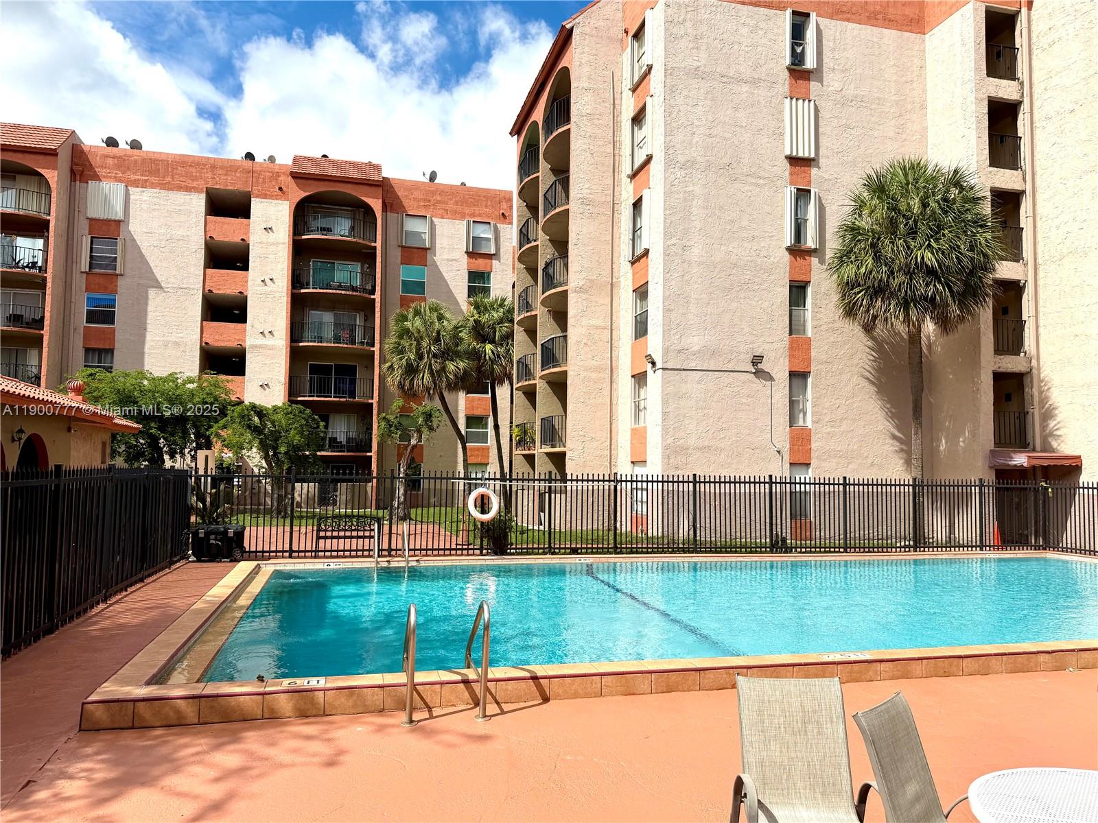 5201 Northwest 7th Street, Unit 212 Miami, FL 33126 - Photo 8 of 34 a view of a building with a backyard