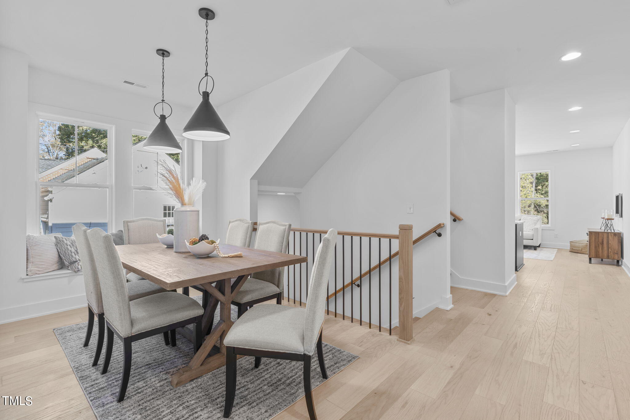 901 Athens Drive, Unit 101 Raleigh, NC 27606 - Photo 22 of 62 a view of a dining room and livingroom with furniture wooden floor a chandelier