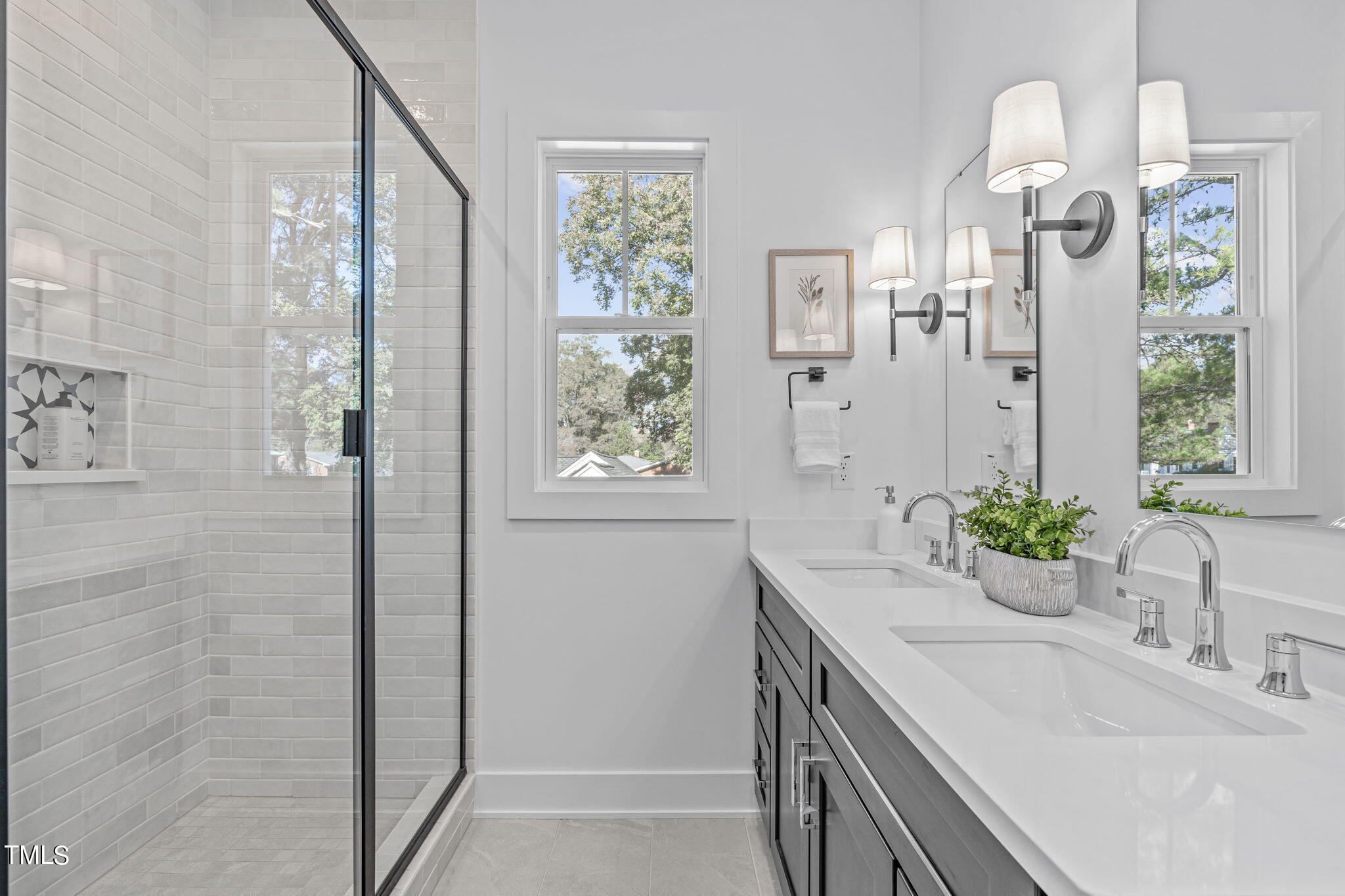 901 Athens Drive, Unit 101 Raleigh, NC 27606 - Photo 39 of 62 a bathroom with a granite countertop sink a large mirror and a shower