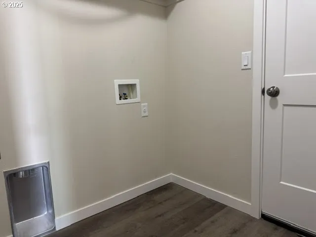 a view of a small space with wooden floor and a window