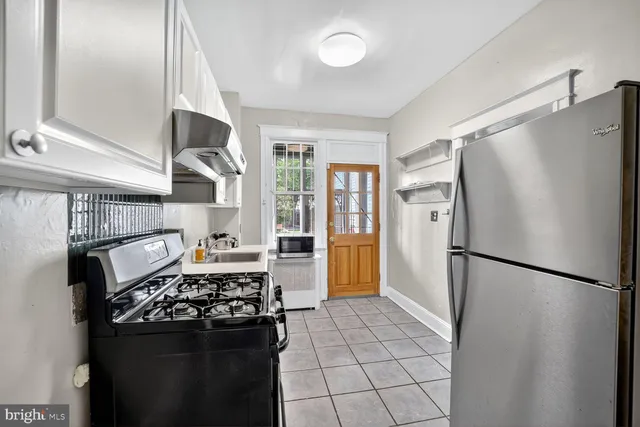 a kitchen with a stove a refrigerator and a stove