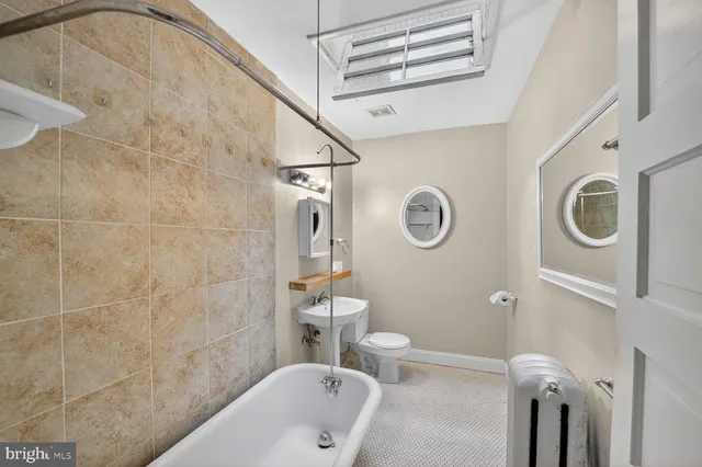 a bathroom with a toilet a sink and a shower