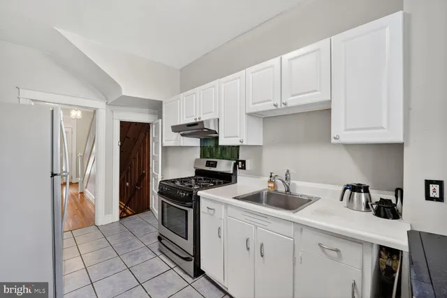 a kitchen with stainless steel appliances a sink stove and refrigerator