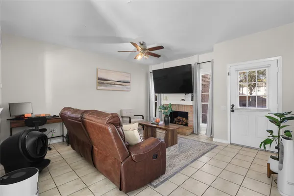 a living room with furniture potted plant and a chandelier