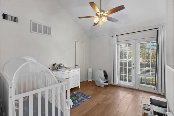 a bedroom with furniture and wooden floor