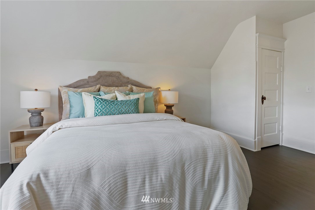 736 North 76th Street Seattle, WA 98103 - Photo 22 of 40 a bedroom with a bed and wooden floor