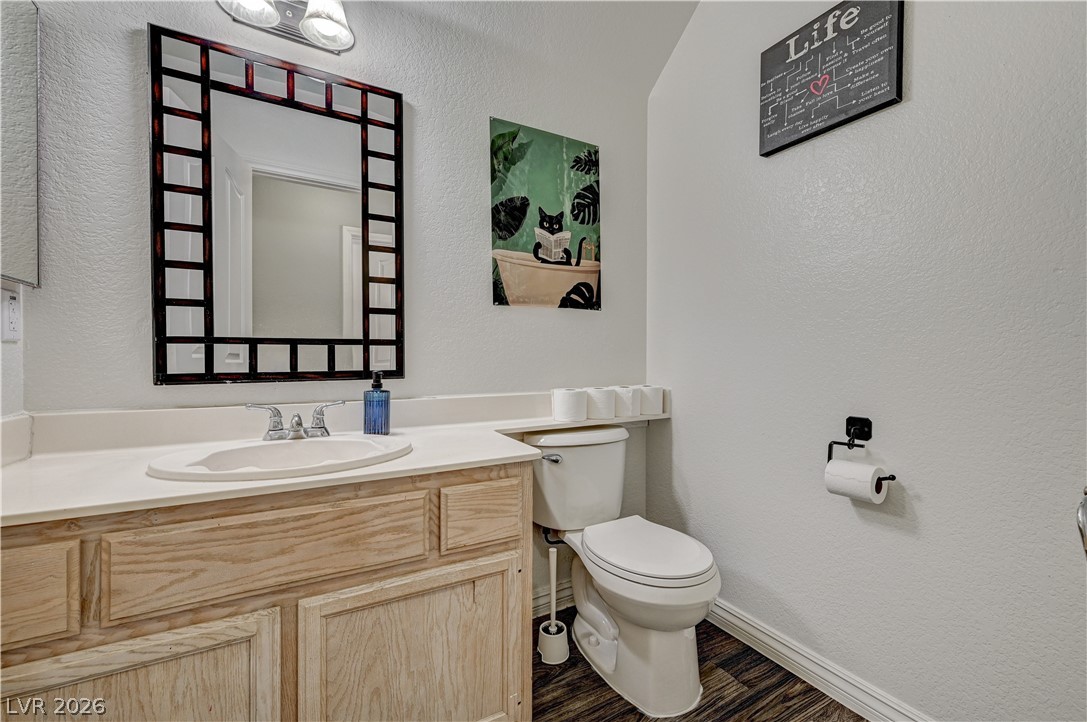 8863 Chapman Point Las Vegas, NV 89129 - Photo 19 of 22 Half bath featuring a textured wall and vanity