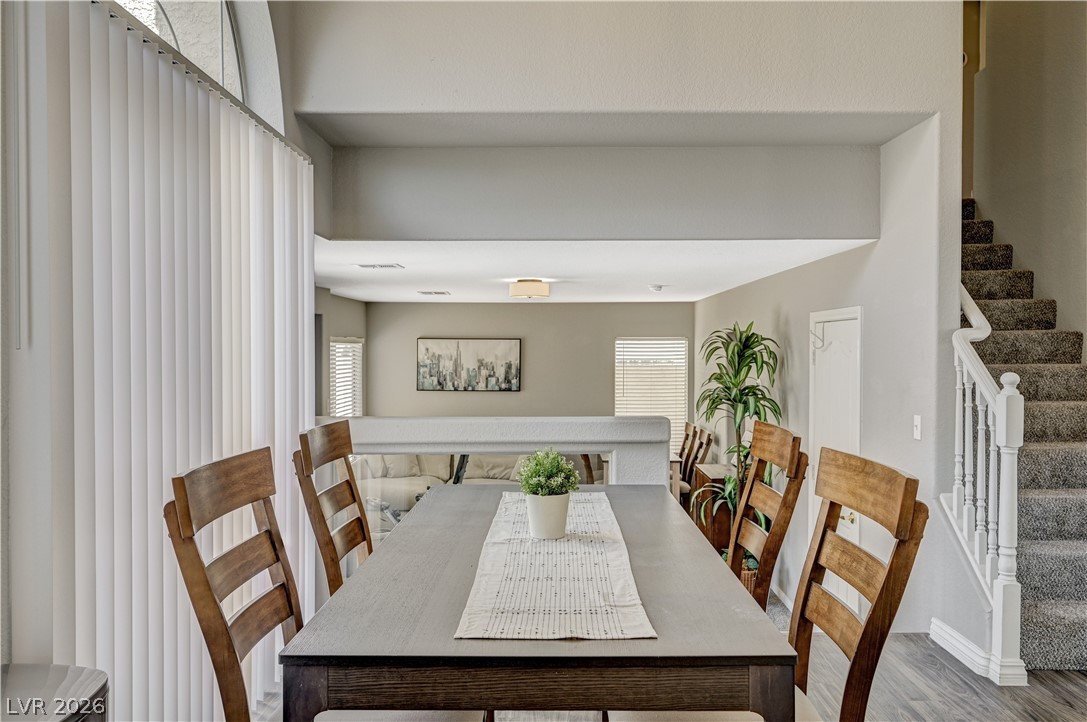 8863 Chapman Point Las Vegas, NV 89129 - Photo 7 of 22 Dining area featuring stairway and wood finished floors