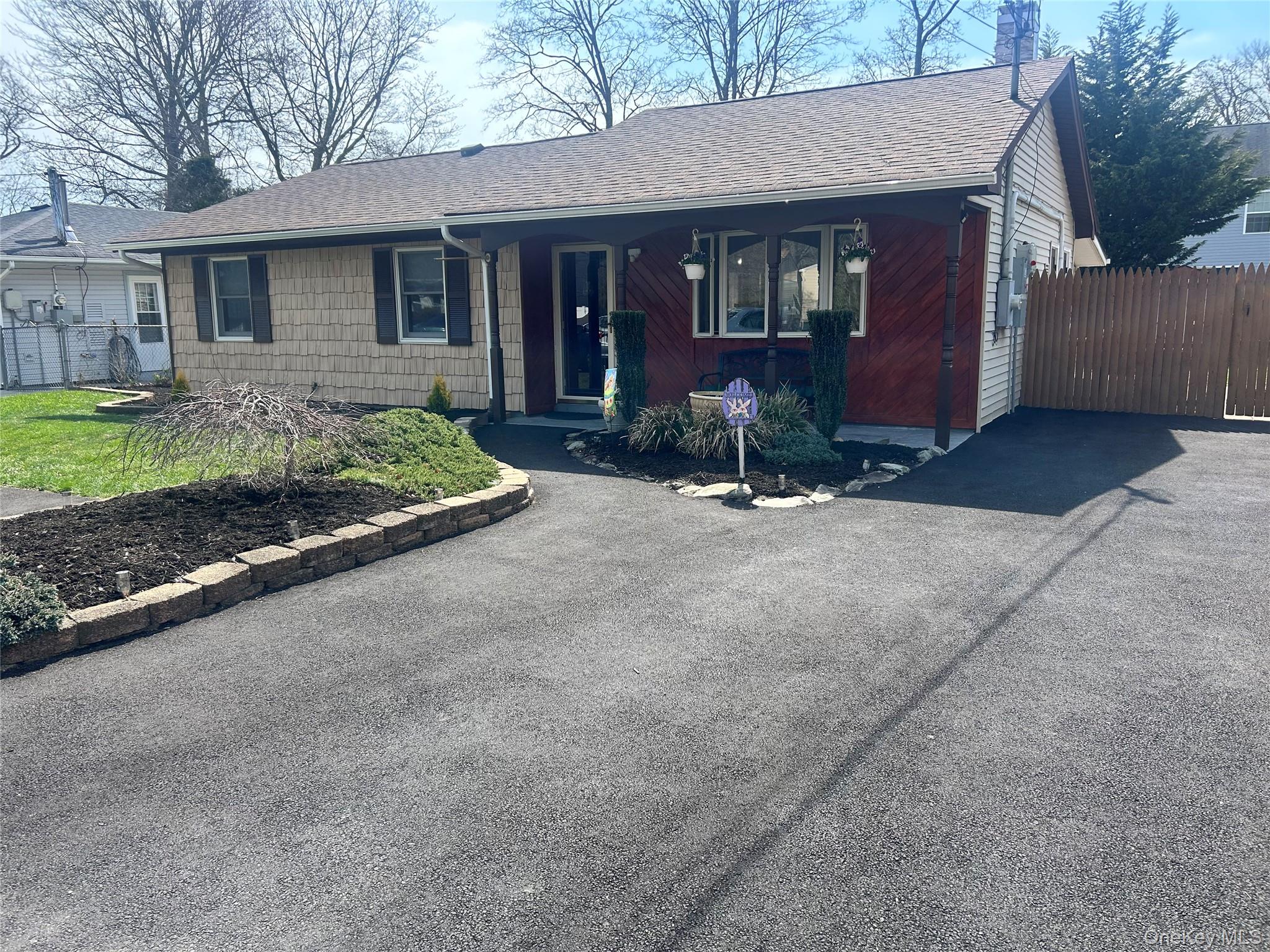 136 B Hampton Avenue Mastic, NY 11950 - Photo 1 of 21 a front view of a house with a yard and garage