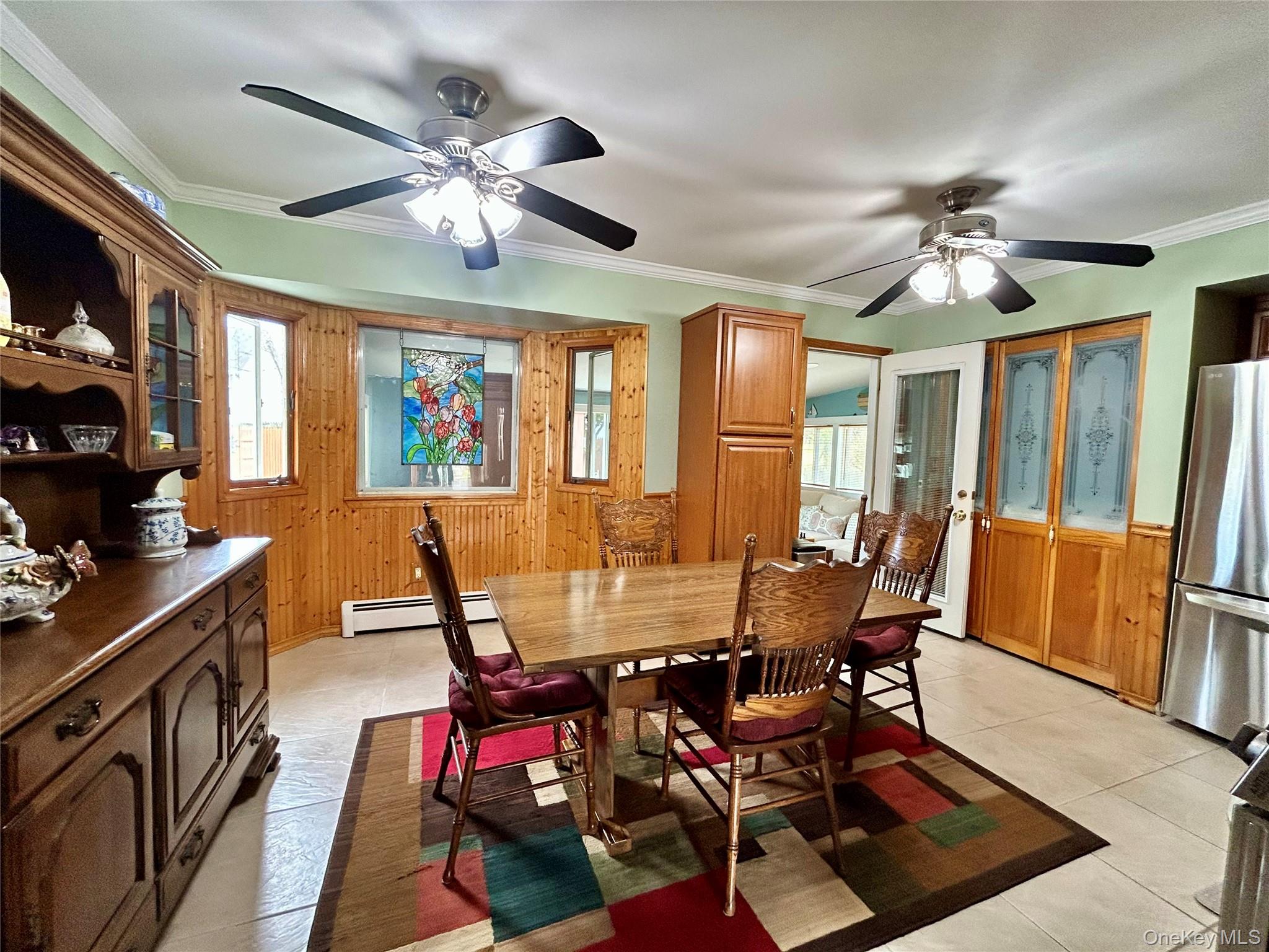 136 B Hampton Avenue Mastic, NY 11950 - Photo 11 of 21 a view of a dining room with furniture window and wooden floor