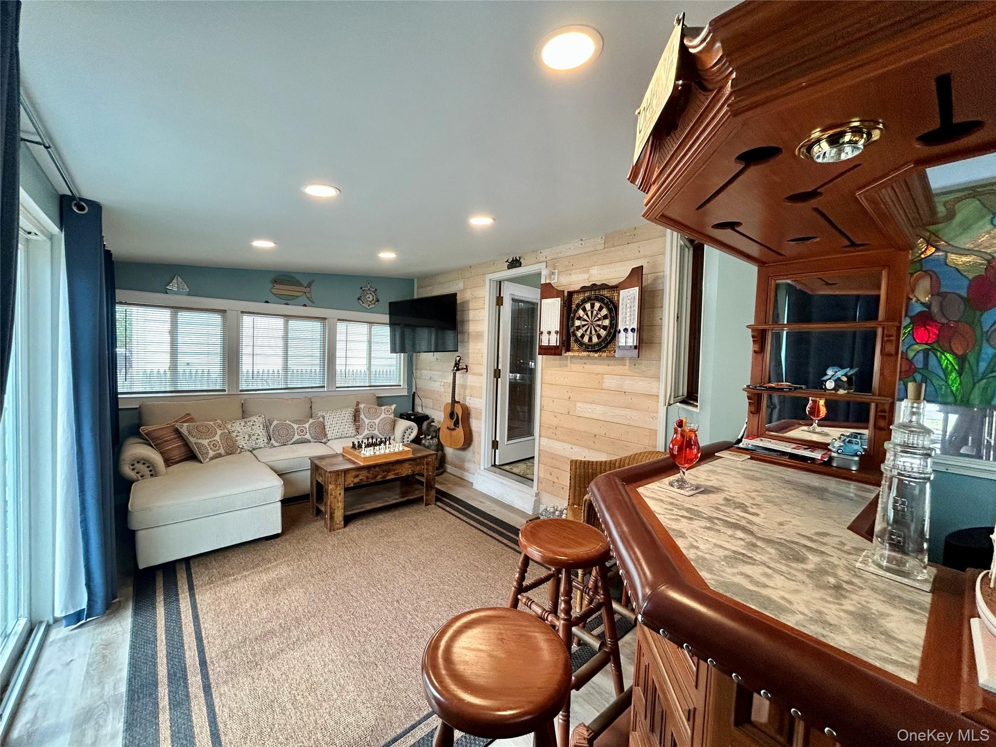 136 B Hampton Avenue Mastic, NY 11950 - Photo 13 of 21 a living room with furniture and a flat screen tv