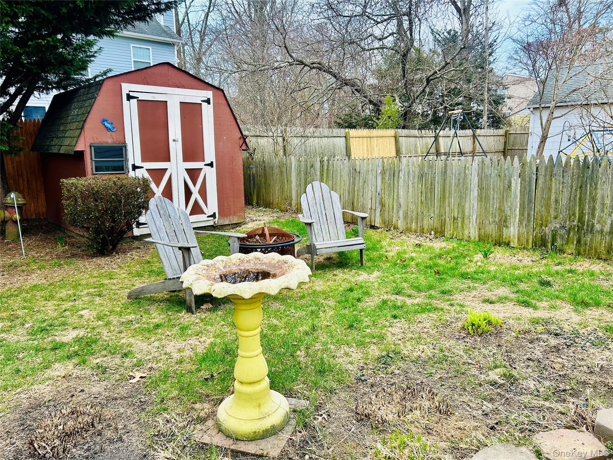 136 B Hampton Avenue Mastic, NY 11950 - Photo 16 of 21 a backyard of a house with table and chairs