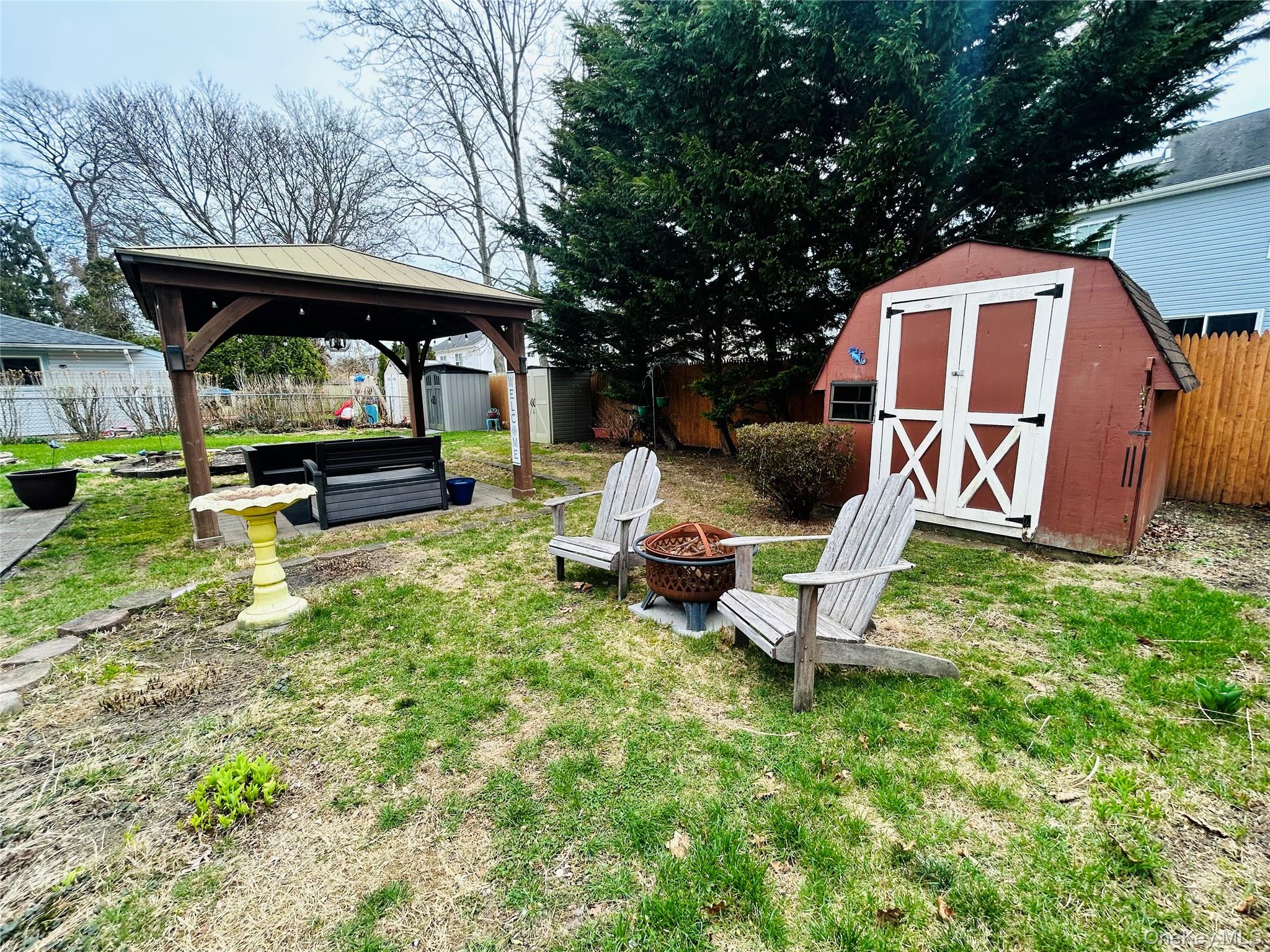 136 B Hampton Avenue Mastic, NY 11950 - Photo 17 of 21 a backyard of a house with table and chairs