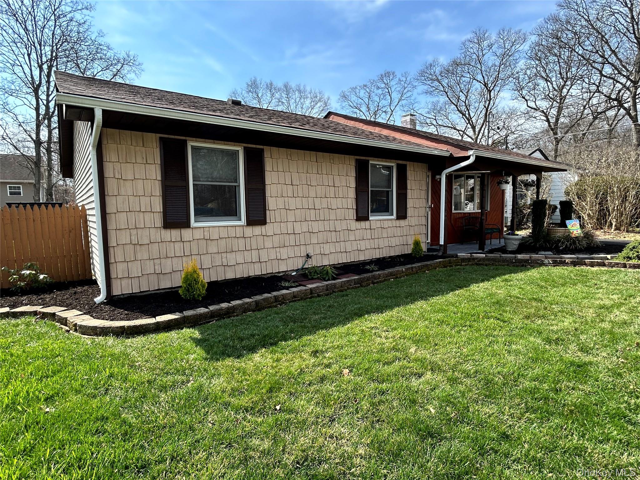 136 B Hampton Avenue Mastic, NY 11950 - Photo 2 of 21 a front view of a house with a garden