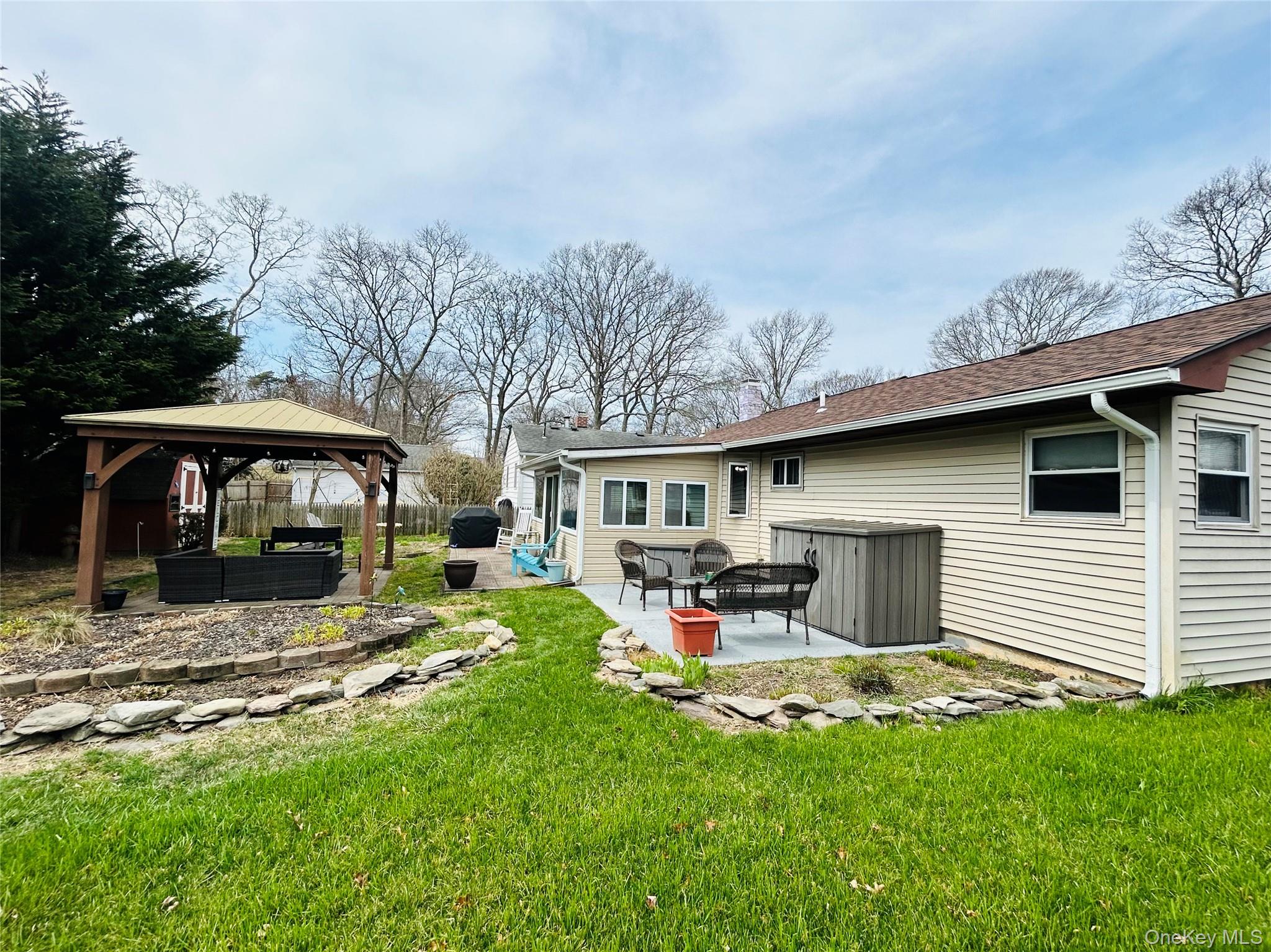 136 B Hampton Avenue Mastic, NY 11950 - Photo 21 of 21 a view of a yard with a car parked in it