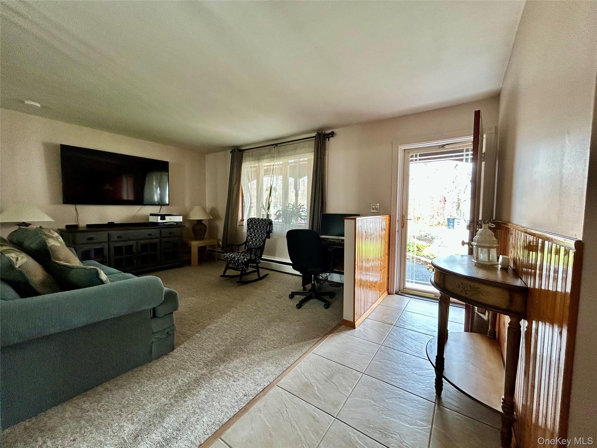 136 B Hampton Avenue Mastic, NY 11950 - Photo 3 of 21 a living room with furniture and a flat screen tv