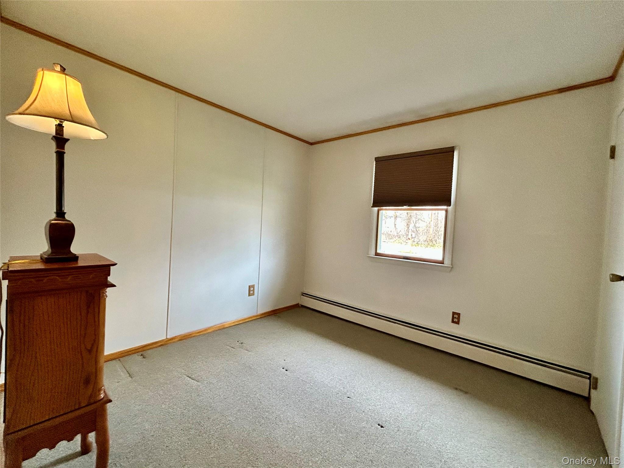 136 B Hampton Avenue Mastic, NY 11950 - Photo 4 of 21 a view of an empty room with a window