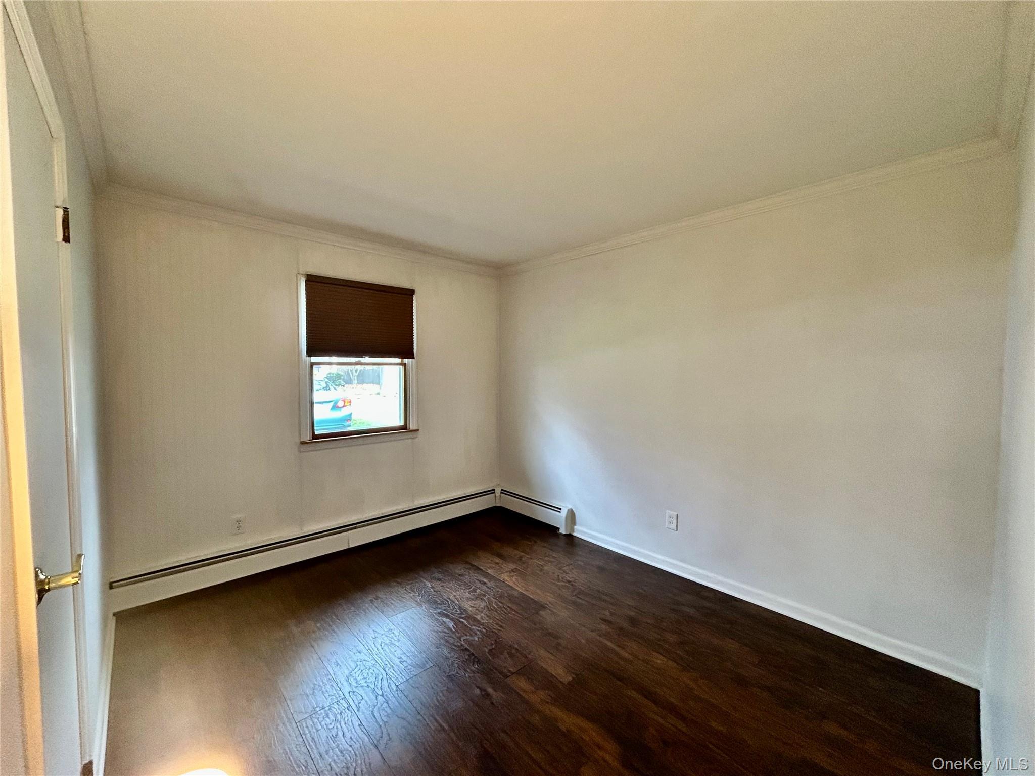 136 B Hampton Avenue Mastic, NY 11950 - Photo 5 of 21 an empty room with wooden floor and windows