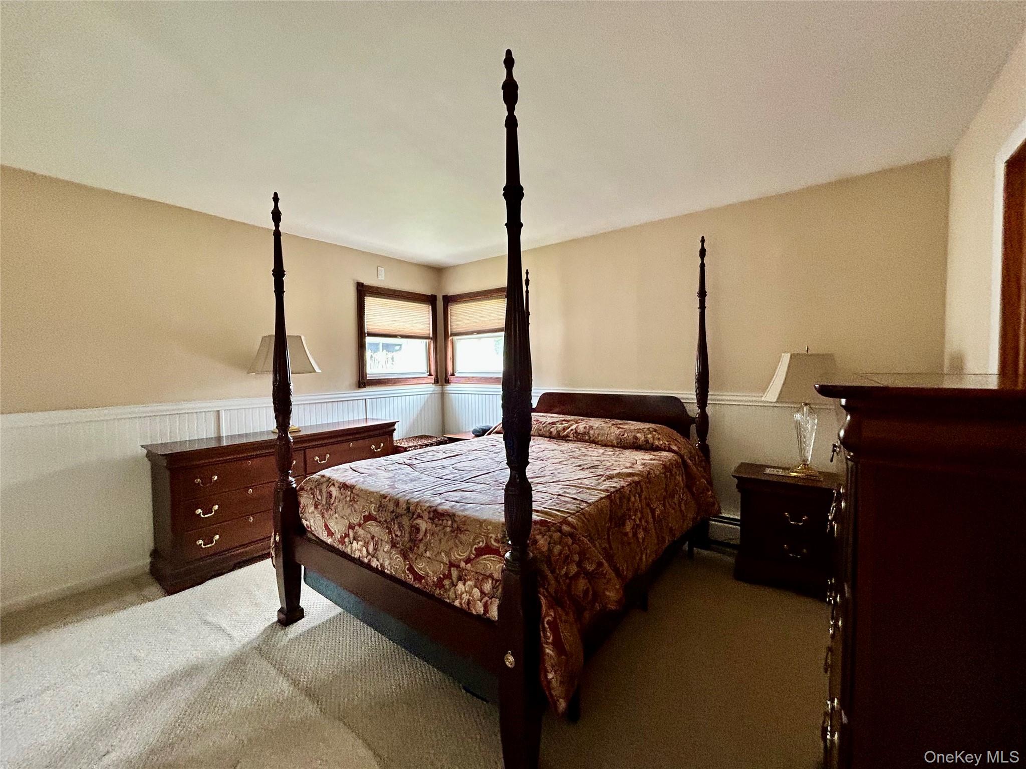 136 B Hampton Avenue Mastic, NY 11950 - Photo 6 of 21 a bed sitting in a bedroom next to a window