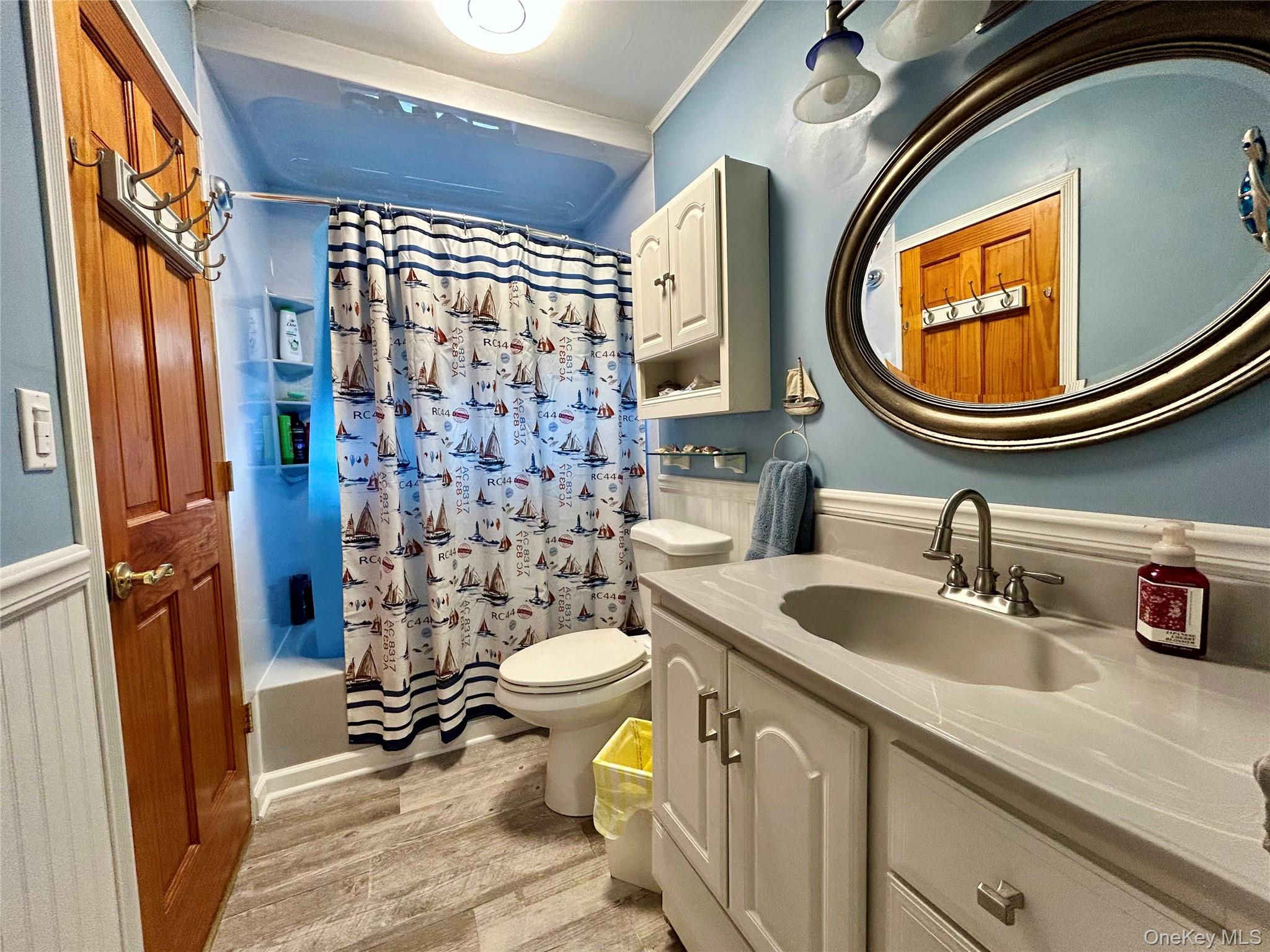 136 B Hampton Avenue Mastic, NY 11950 - Photo 7 of 21 a bathroom with a sink a toilet and a mirror