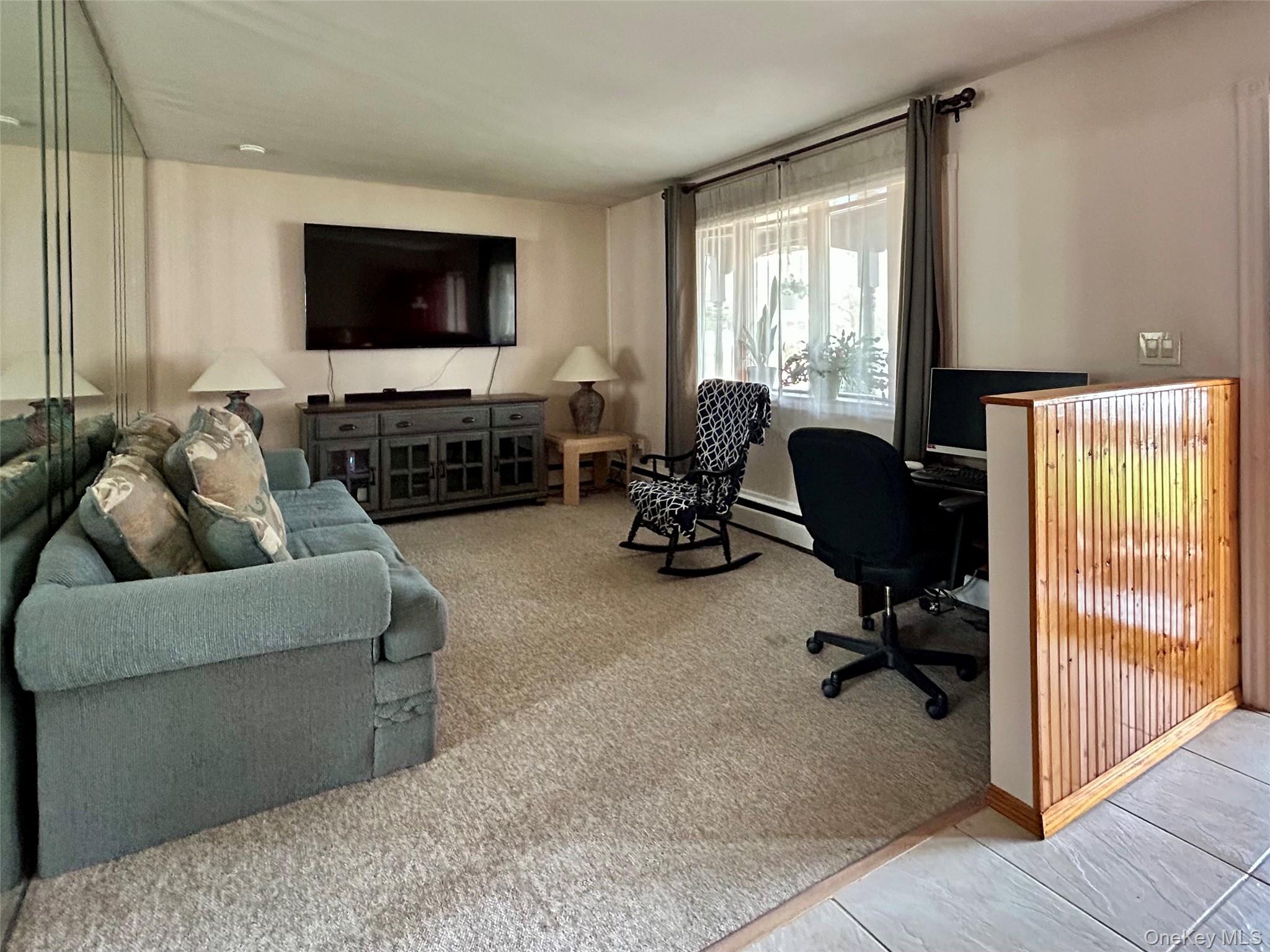 136 B Hampton Avenue Mastic, NY 11950 - Photo 8 of 21 a living room with furniture and a flat screen tv