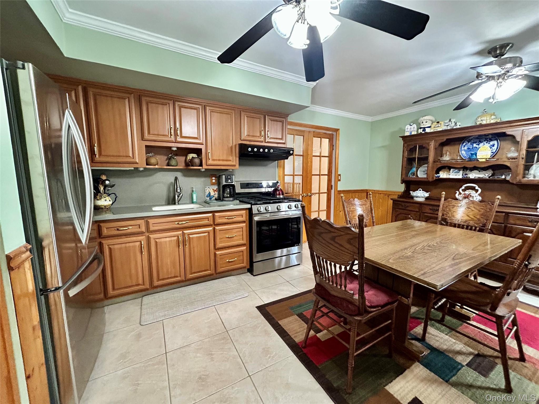 136 B Hampton Avenue Mastic, NY 11950 - Photo 9 of 21 a open kitchen with stainless steel appliances granite countertop a stove refrigerator a sink dishwasher a dining table and chairs with wooden floor