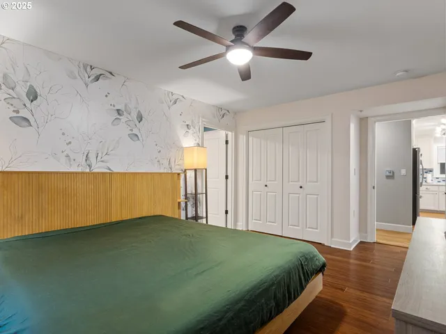 a spacious bedroom with a bed and a chandelier